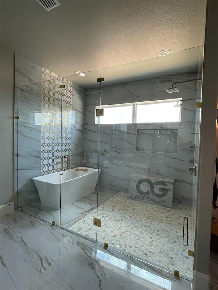 A bathroom with a bathtub and a walk in shower.