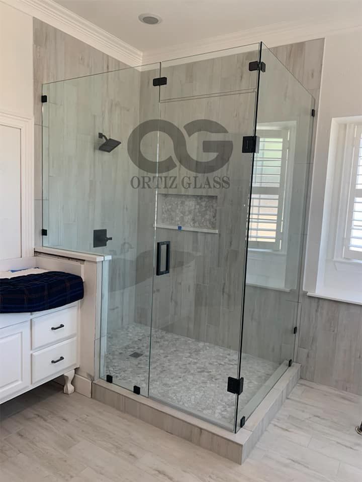 A bathroom with a walk in shower and a sink.