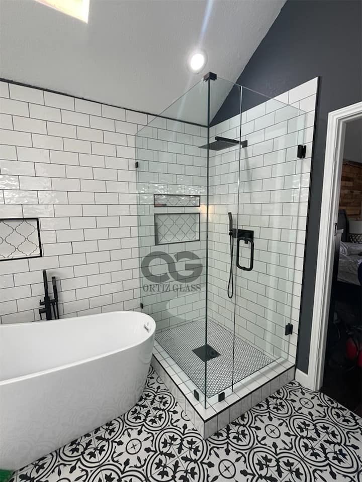 A bathroom with a bathtub and a walk in shower.