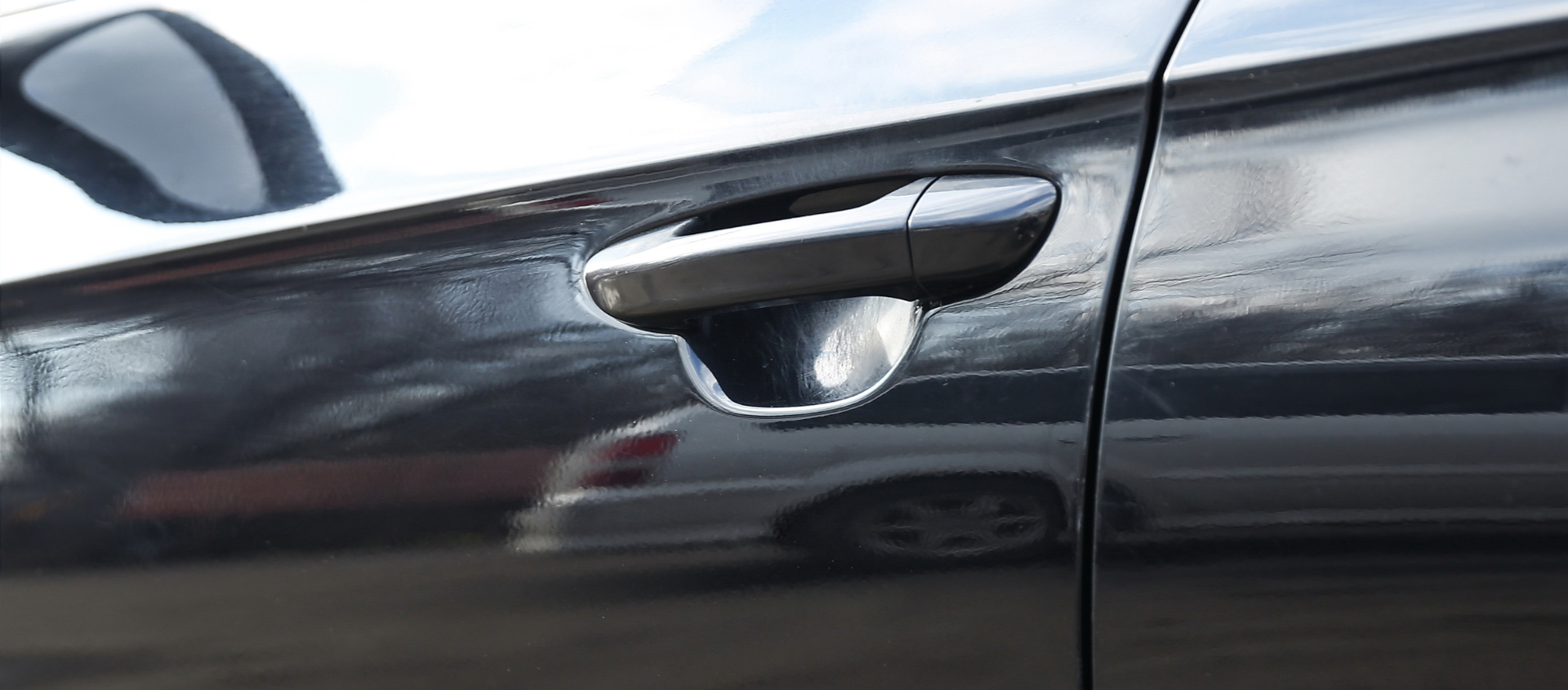a close up of the door handle of a black car