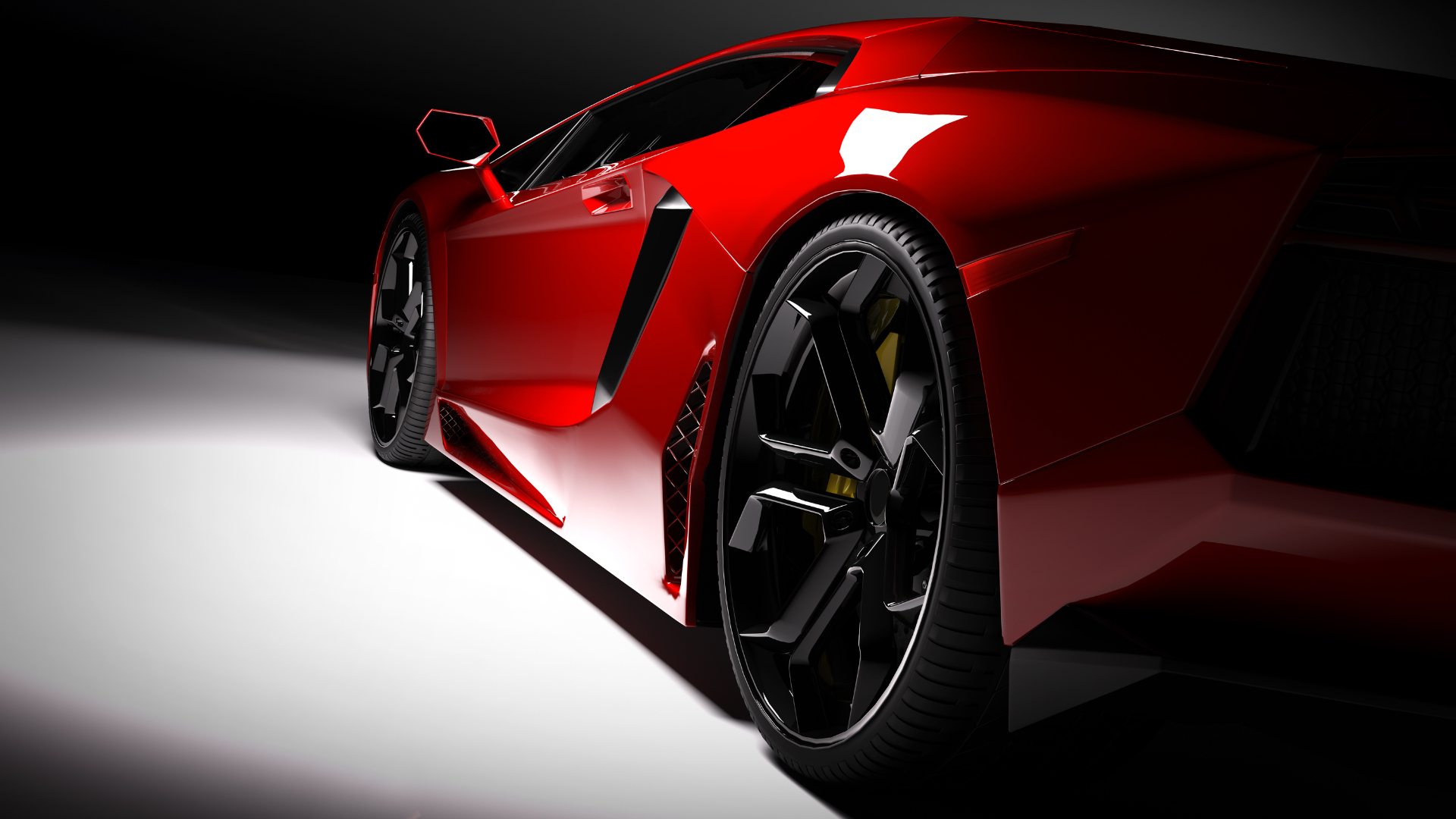 a red sports car with black wheels and tires