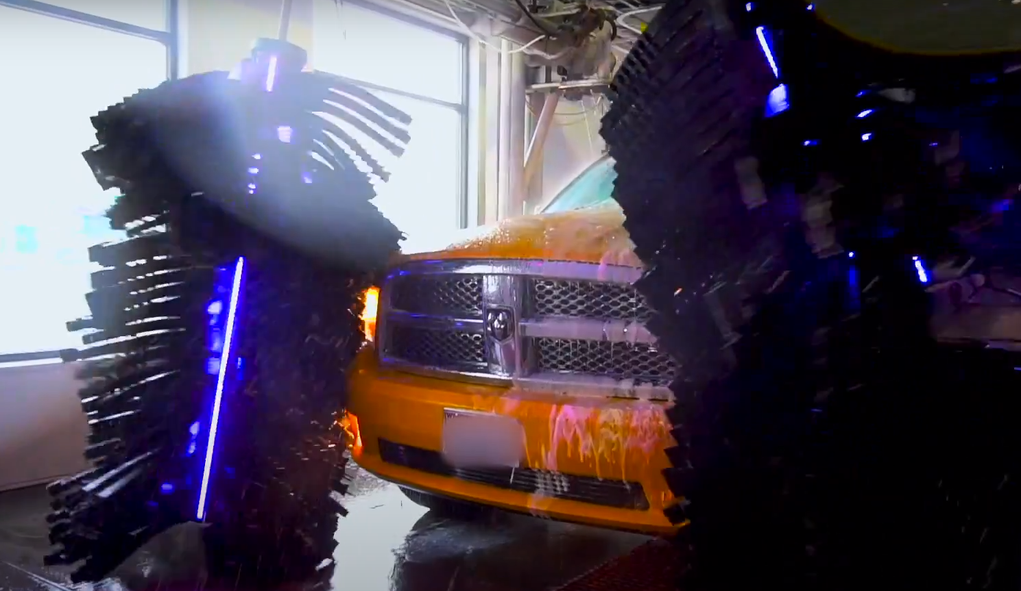 a dodge truck is being washed in a car wash