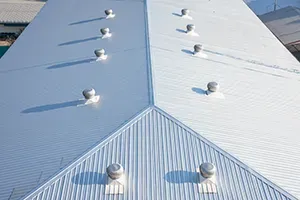 Silver metal roof with multiple rooftop vents.