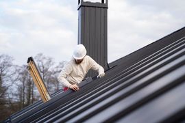 worker working on roof - hermes renovations