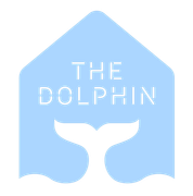 A blue house with a dolphin tail and the words the dolphin