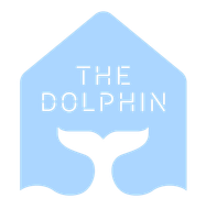 A blue house with a dolphin tail and the words the dolphin