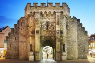 A large stone castle with a gate in the middle of it.