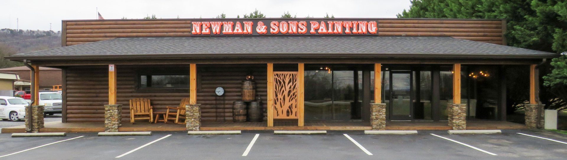 A building with a sign that says newman & sons painting
