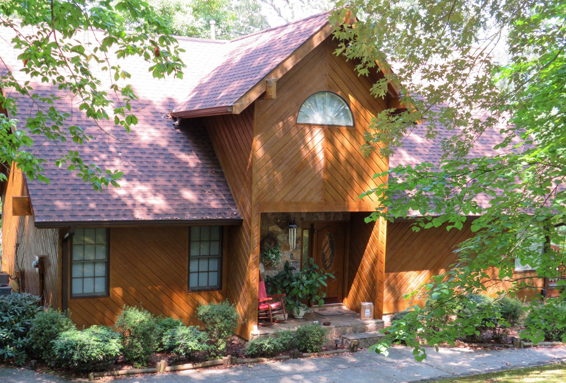 A large wooden house with a purple roof