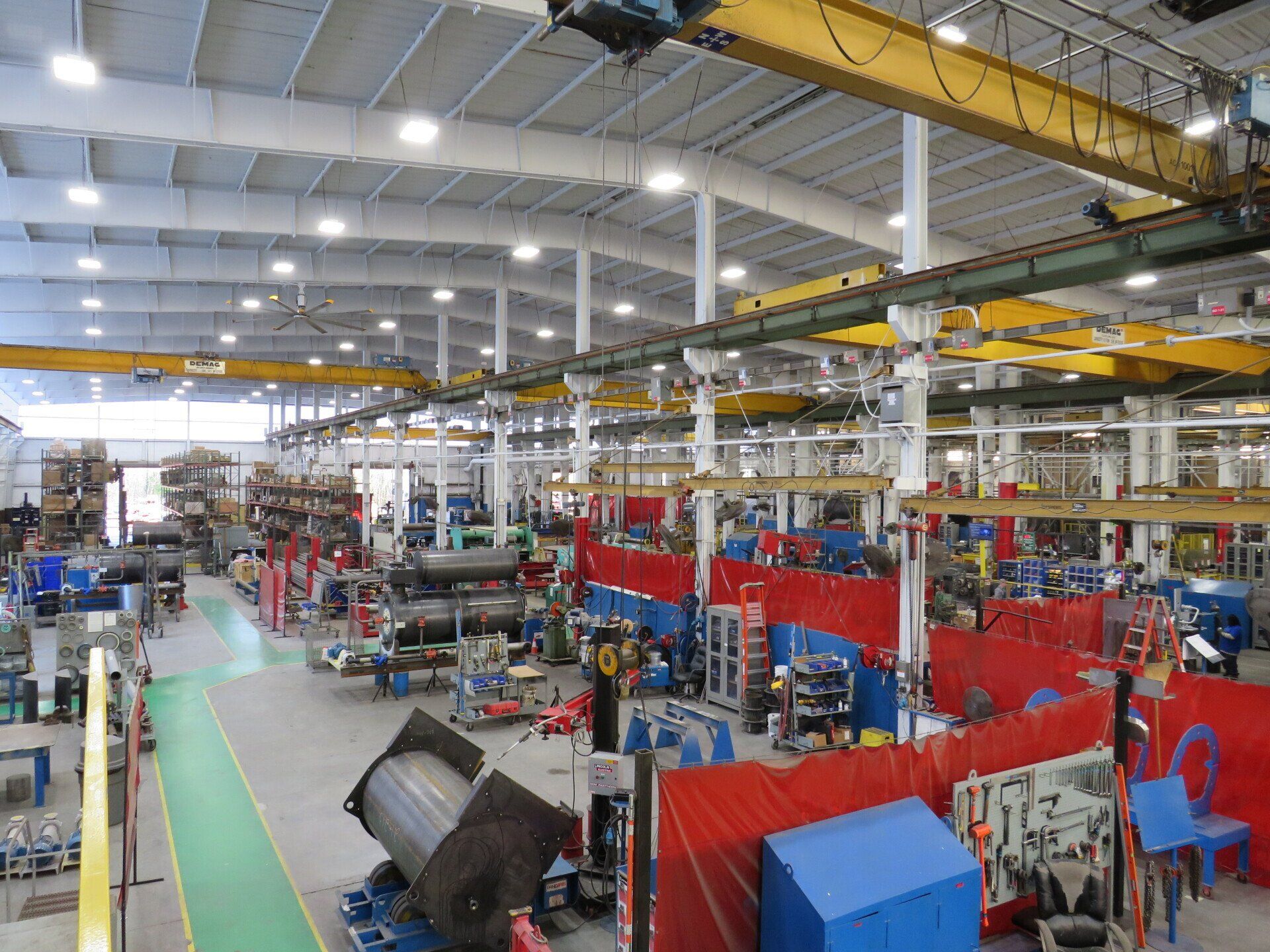A large factory with a lot of machinery and people working in it.