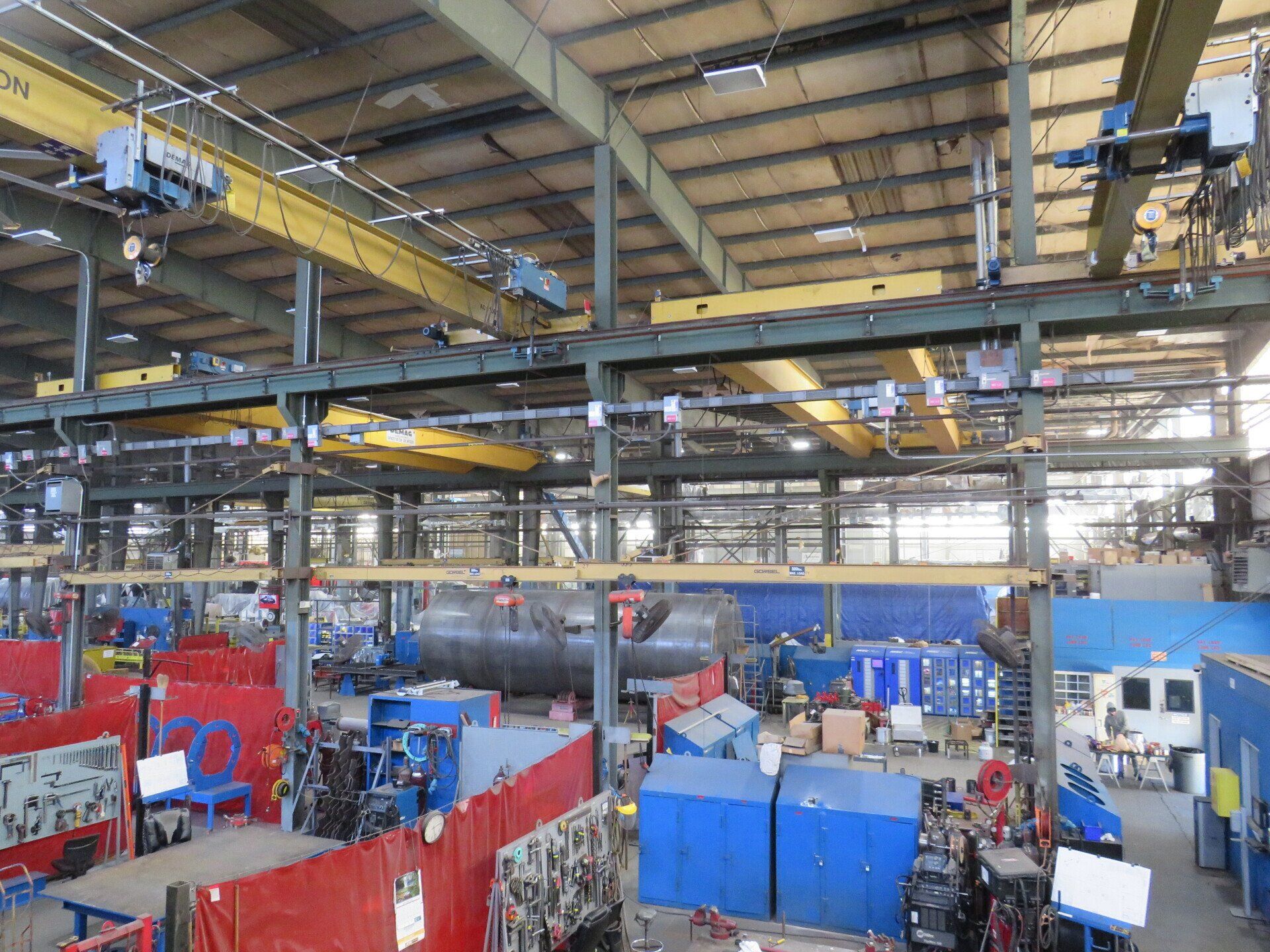 An aerial view of a factory with lots of machinery and cranes.