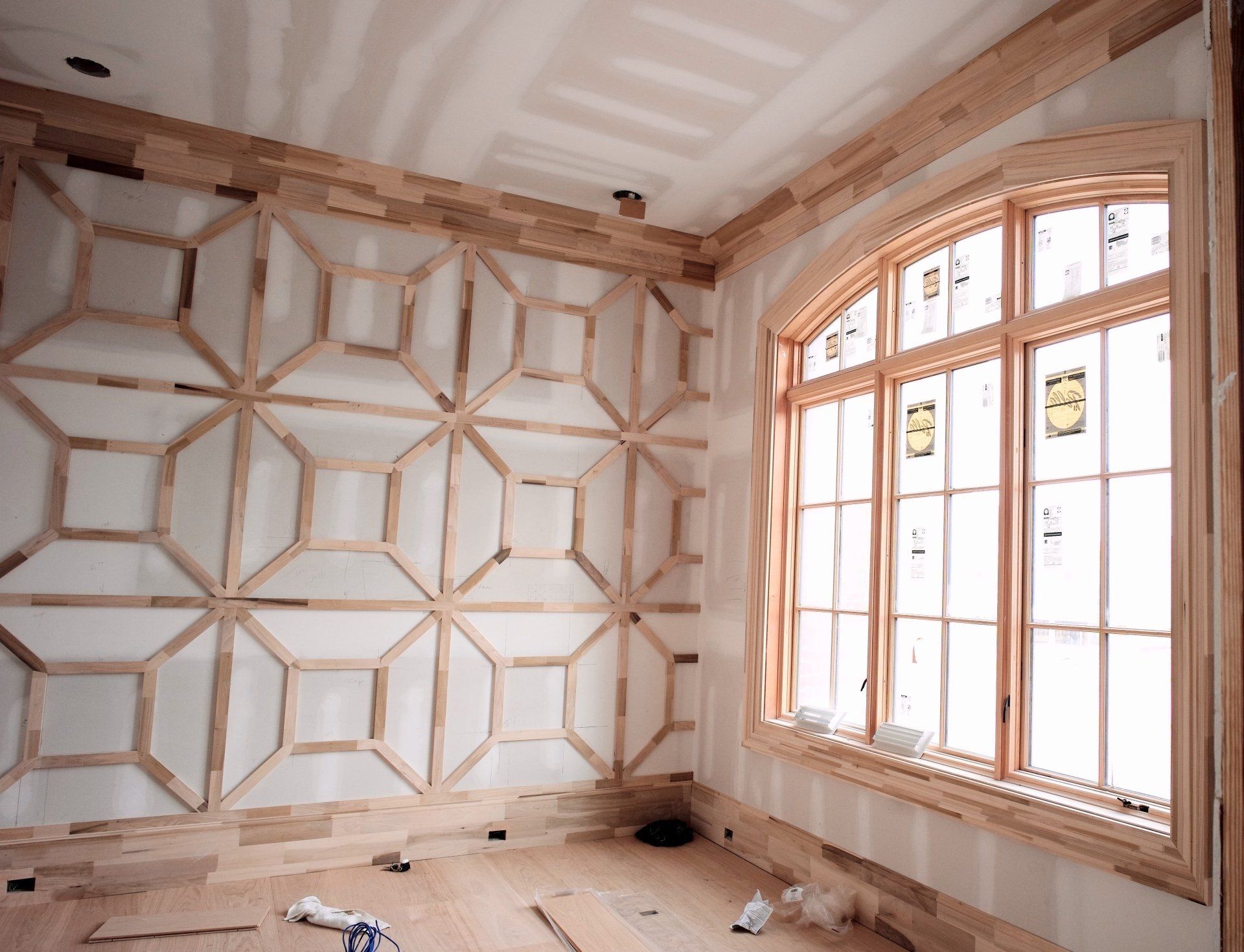 A room with a geometric pattern on the wall and windows