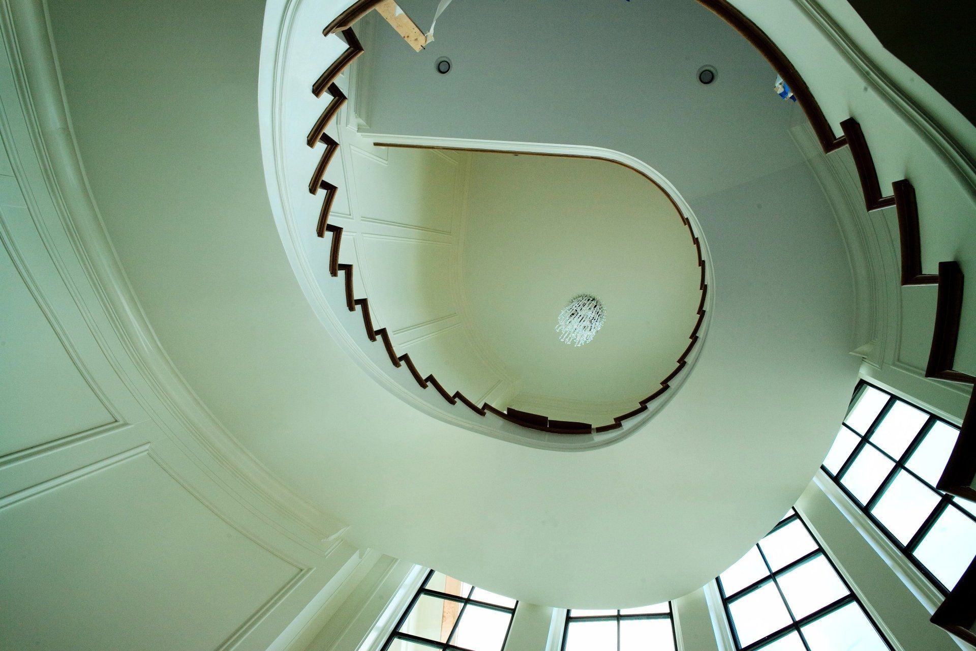 Looking up at a spiral staircase in a building
