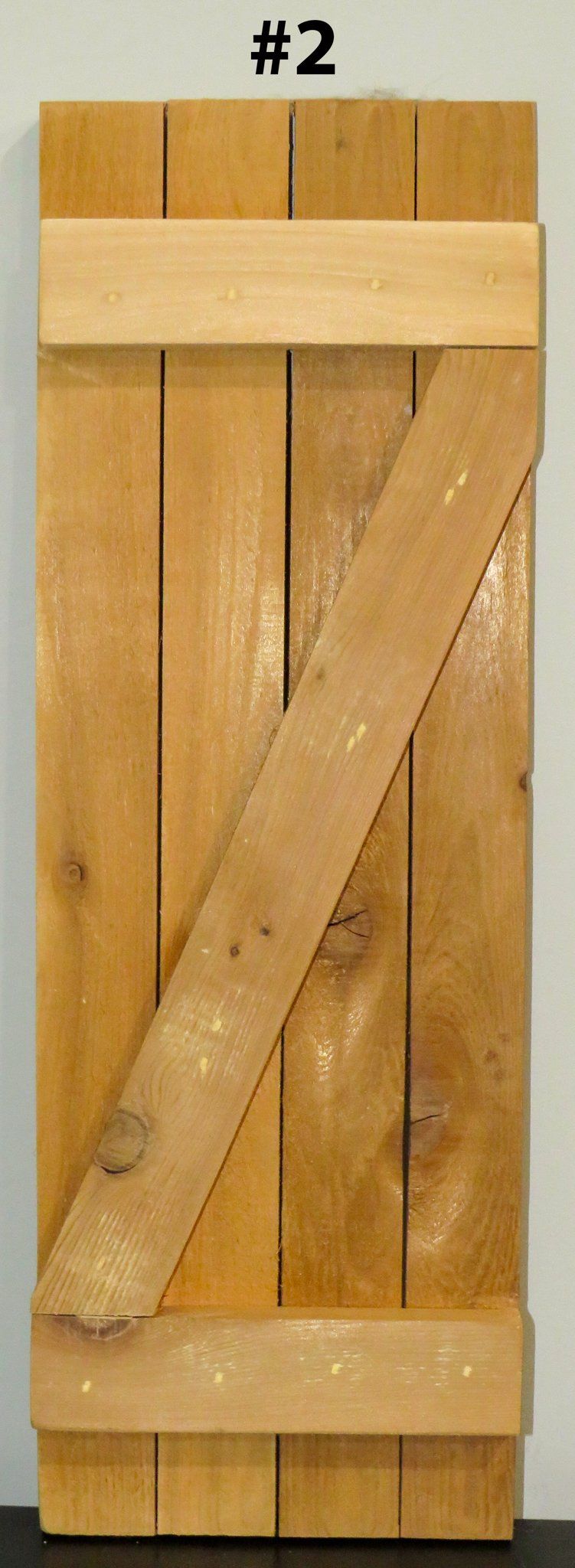 A piece of wood with the number 2 on it is sitting on a table.