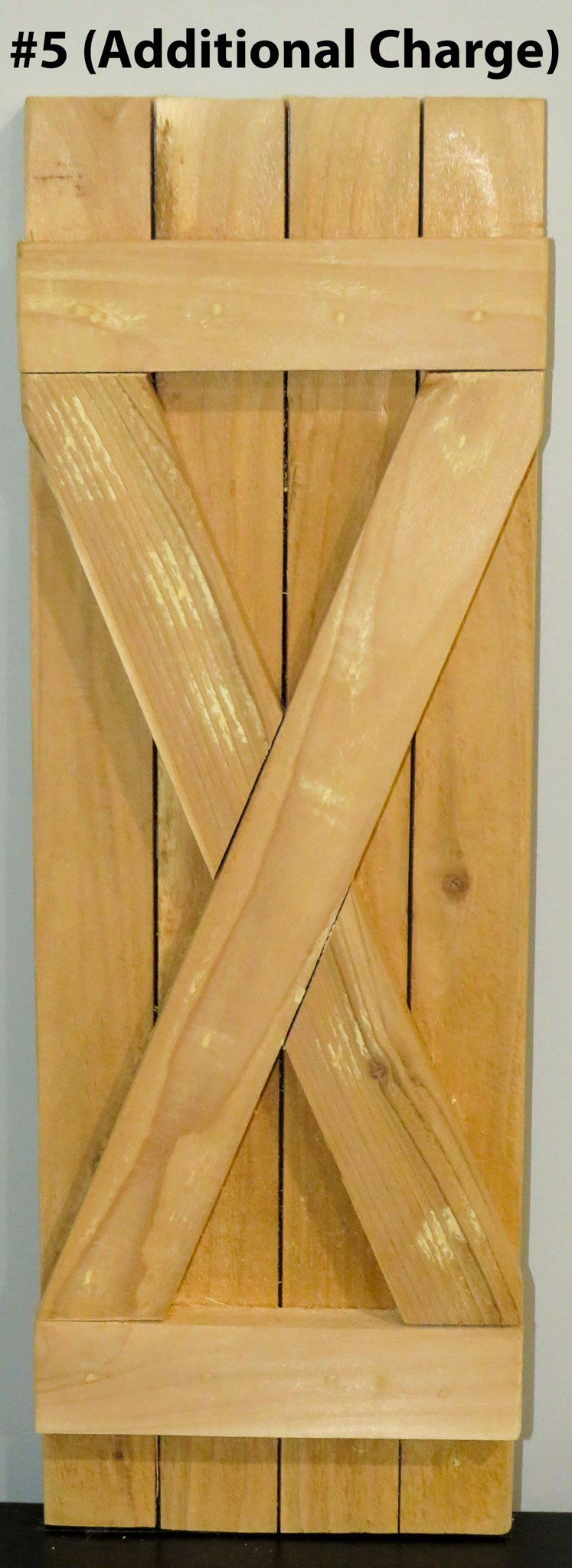A piece of wood with a cross on it is sitting on a table.