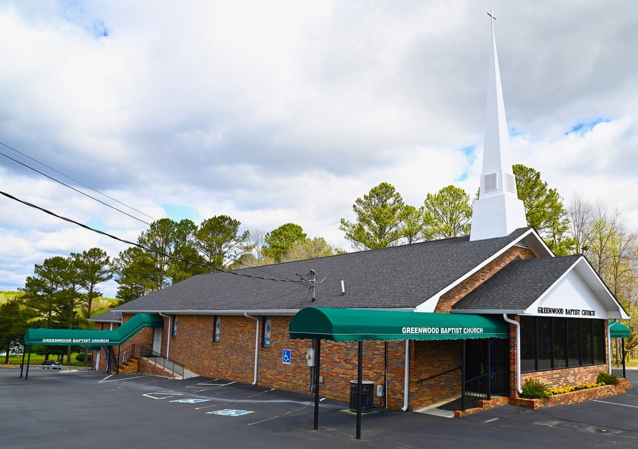 A church with a steeple and a green awning