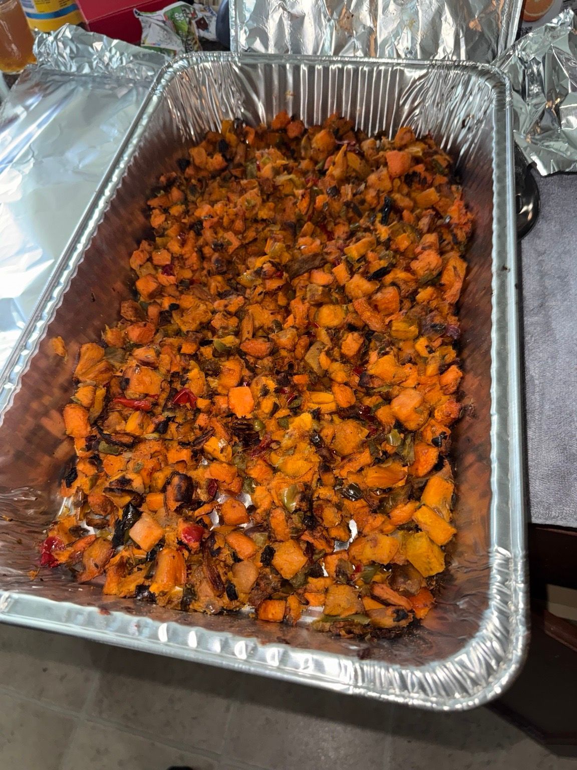 A catering tray filled with roasted vegetables