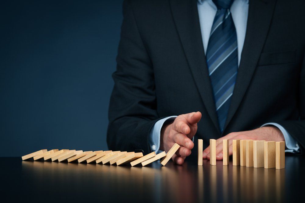 Business Man Knocking Down Blocks — Enterprise OHS in Sydney, NSW