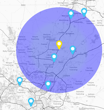 Map with a blue circle, showing several blue markers and a yellow marker in the center.