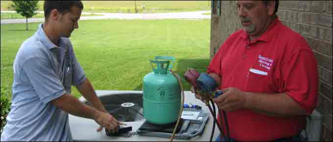 Two Workers Using Manometer — Manchester, TN — Shelton's Heating & Cooling