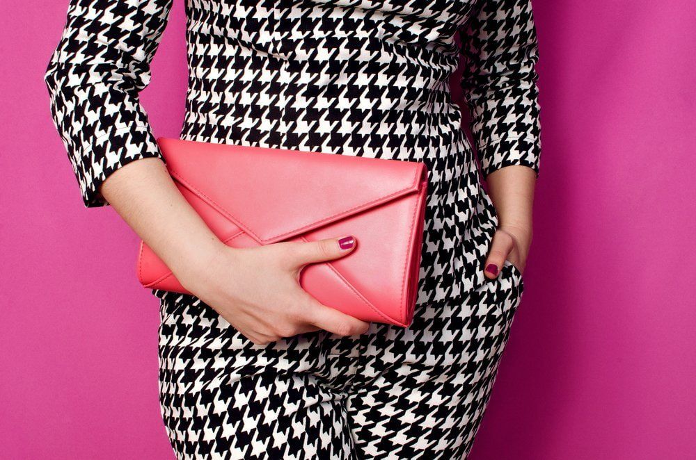 Lady In Black & White Suit Holding Pink Handbag — Boutique in Gympie, QLD