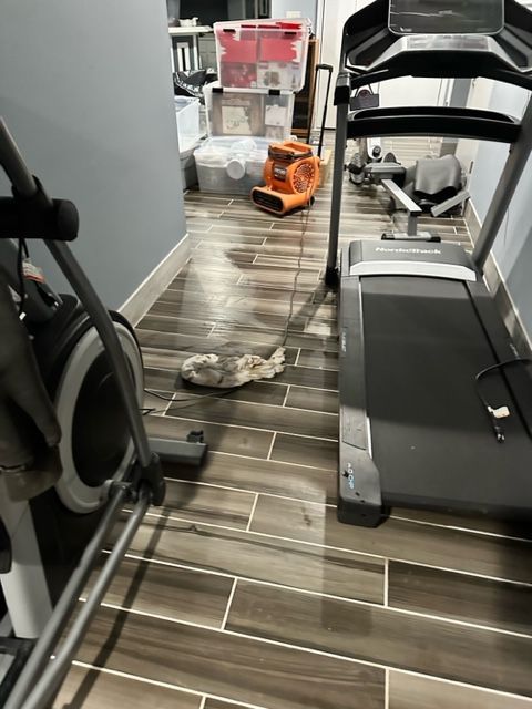 Indoor hallway with two treadmills and a small orange toy truck on the floor.