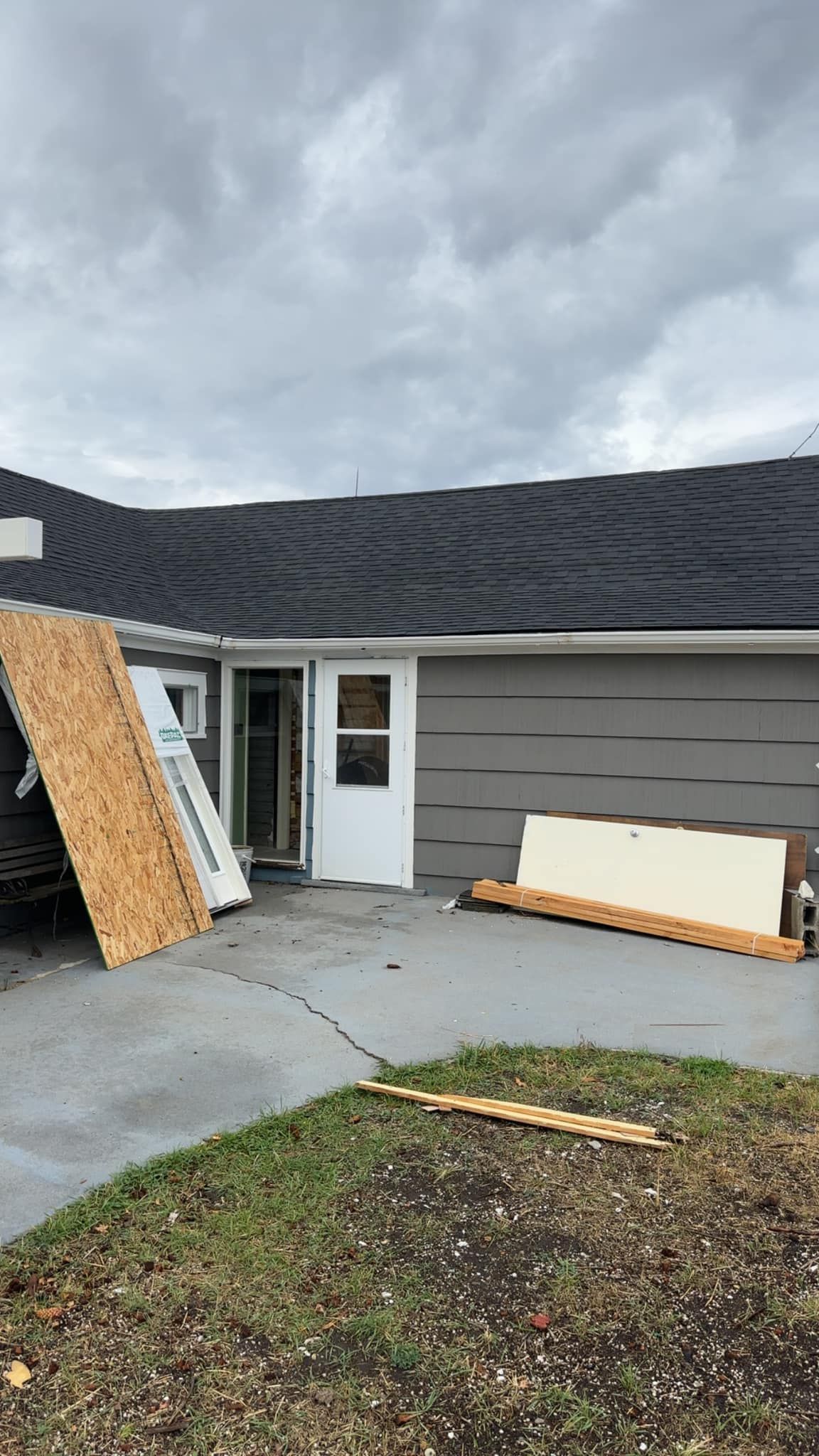 A house with a roof that has been damaged by a storm.