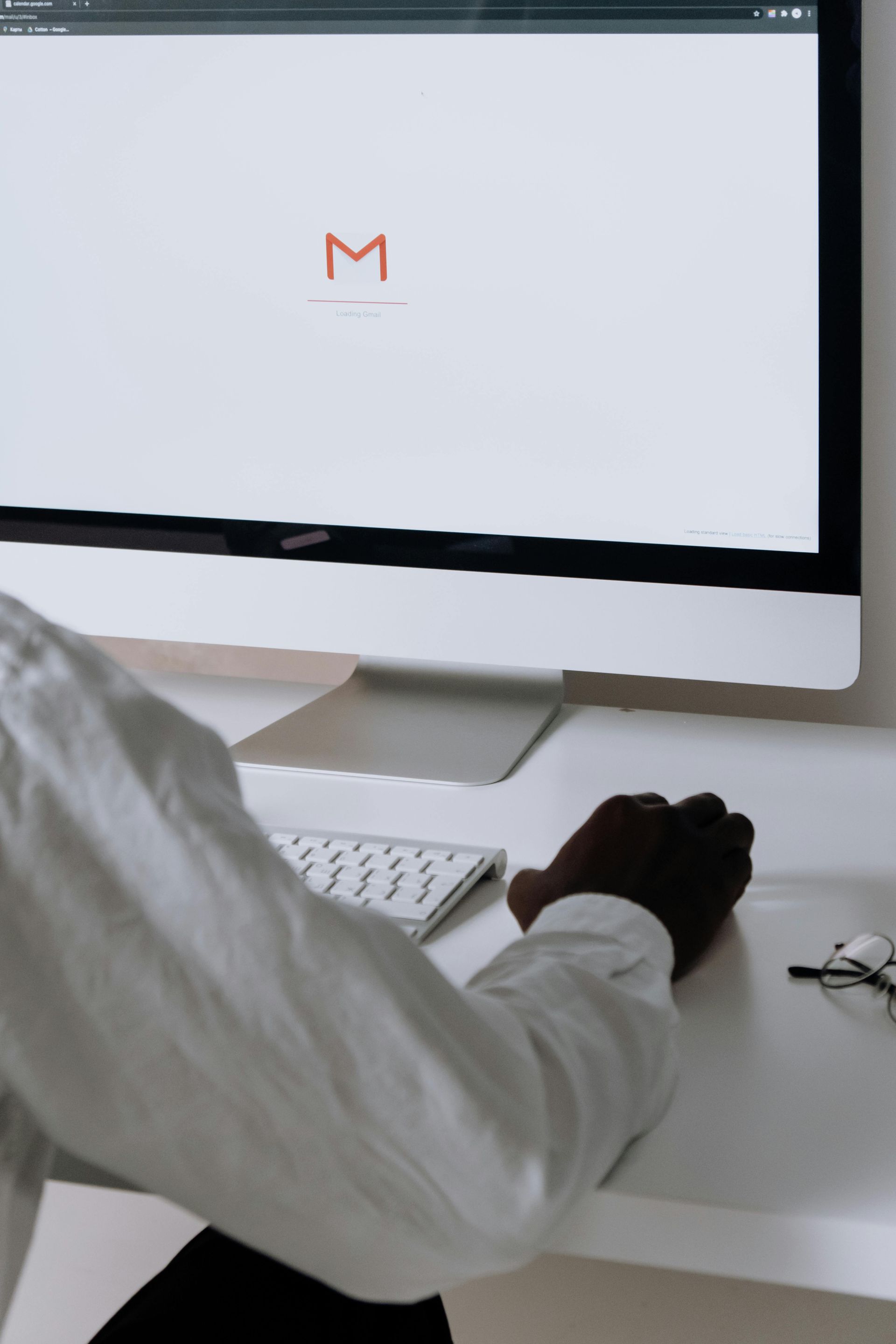 Person at a desk using a computer with a Gmail screen open