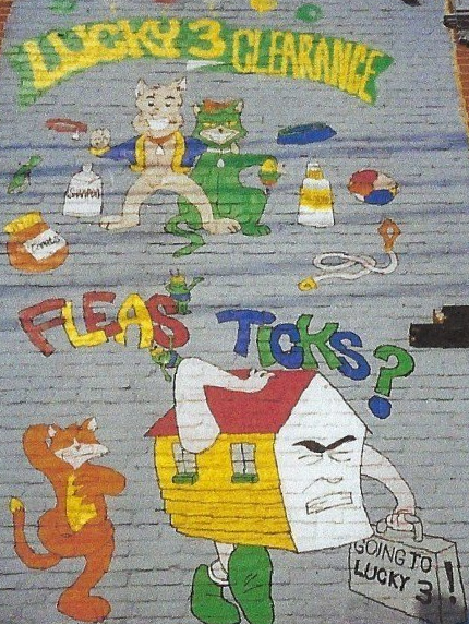 A painting on a wall that says lucky 3 clearance fleas ticks