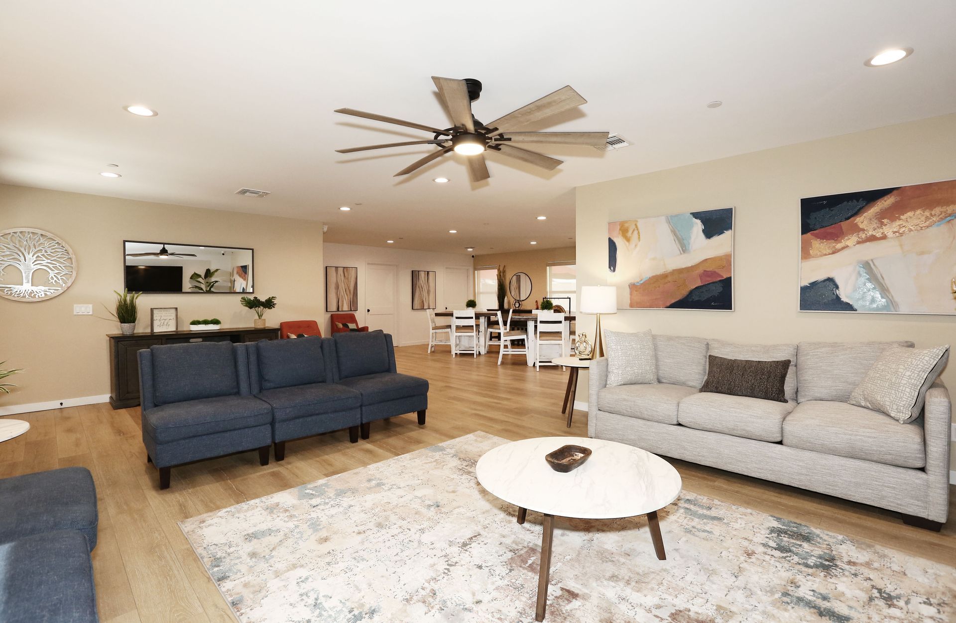 A living room filled with furniture and a ceiling fan.