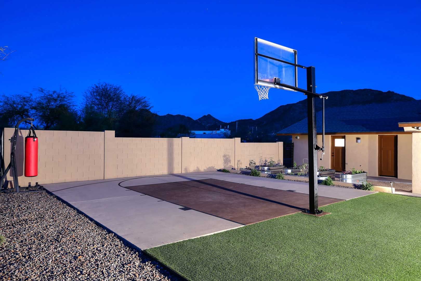 A basketball hoop is in the backyard of a house