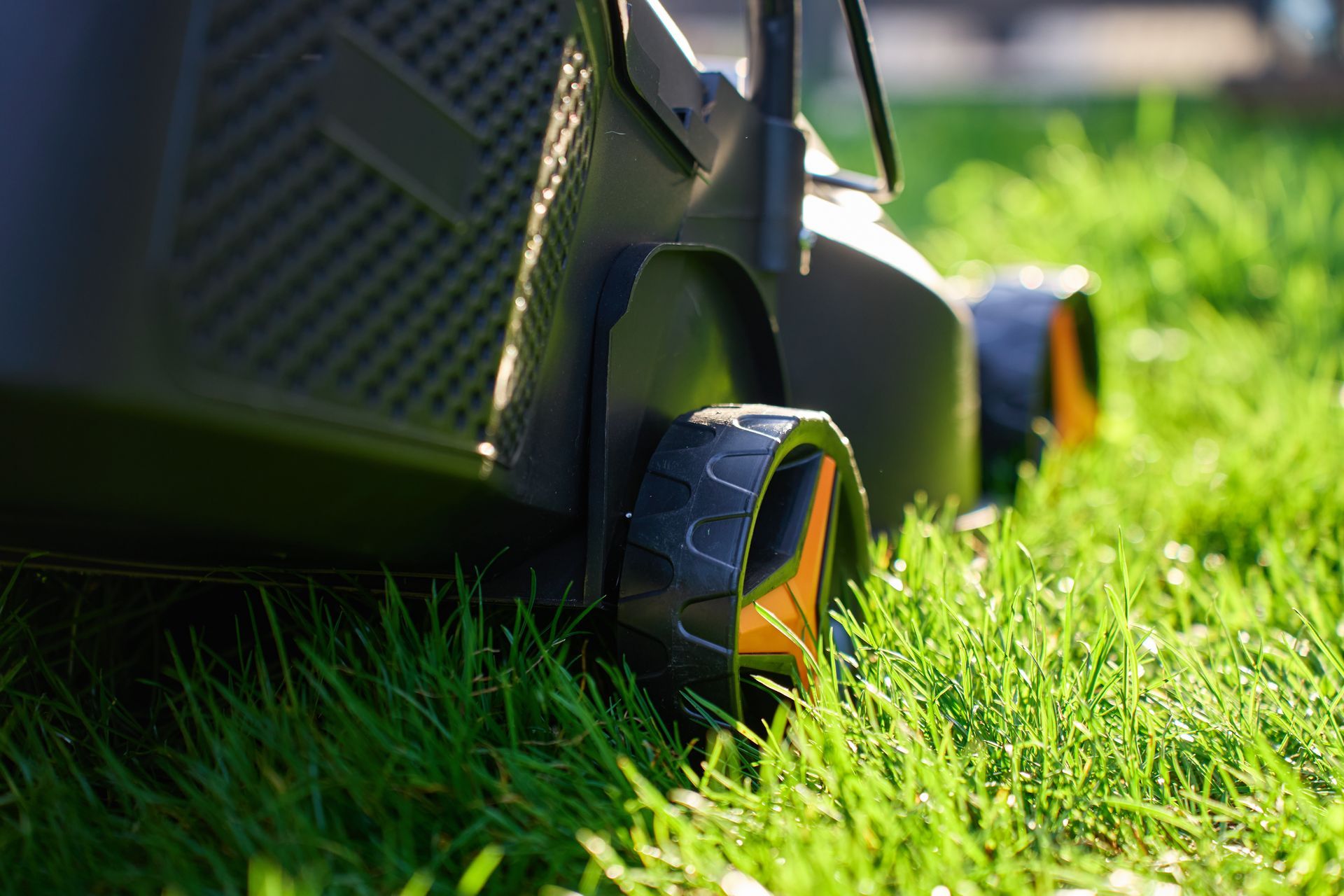 Close-up of a lawn mower cutting residential grass. Close-up of a lawn mower cutting residential grass.