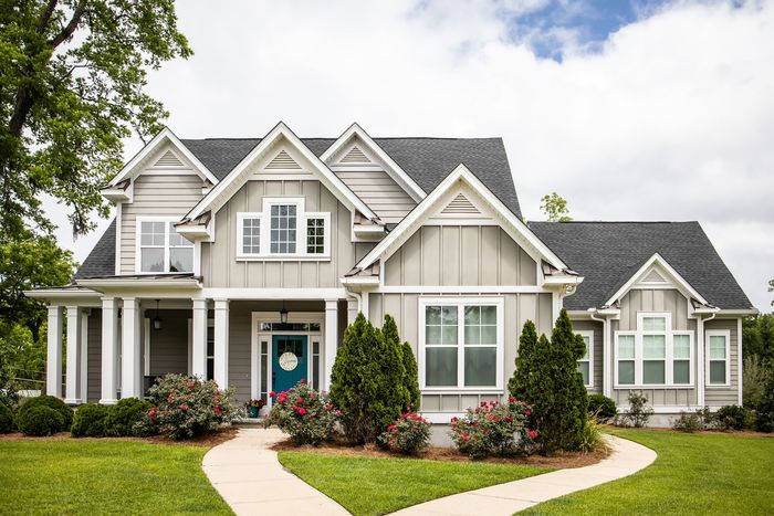 Well-designed front yard with trimmed lawns and decorative plants. Well-designed front yard with trimmed lawns and decorative plants.