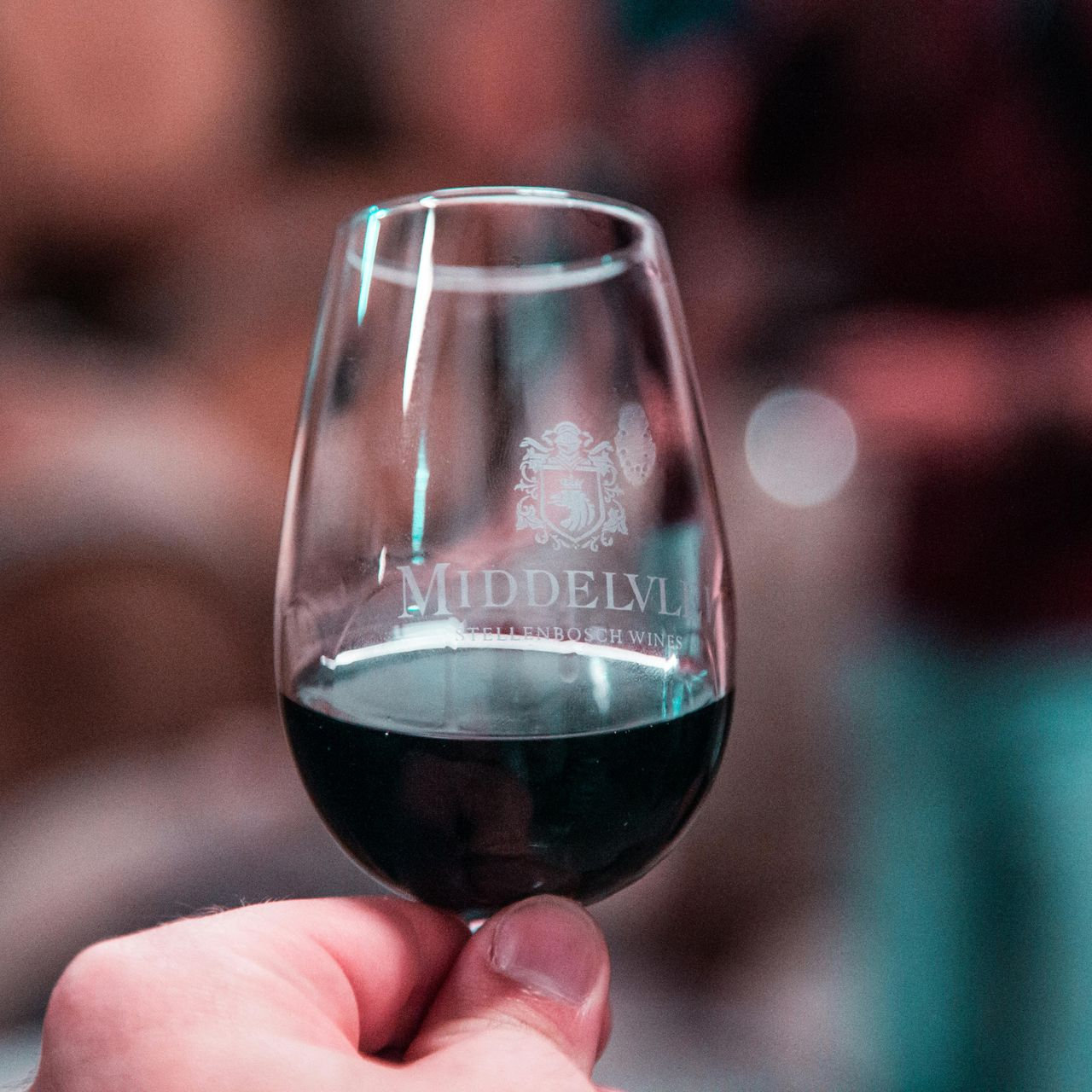 Hand holding a wine glass with