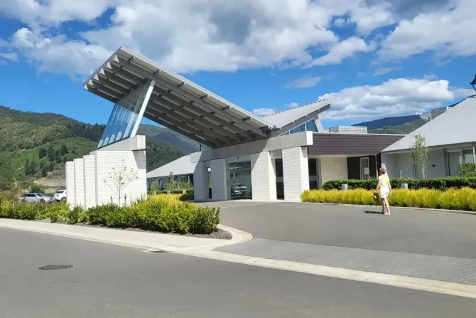 Modern village entrance with mountain