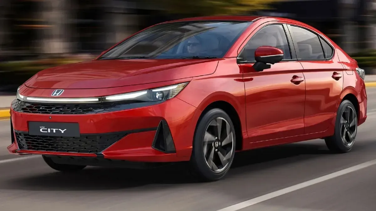 Red Honda sedan driving on a road, blurred background, front three-quarter view