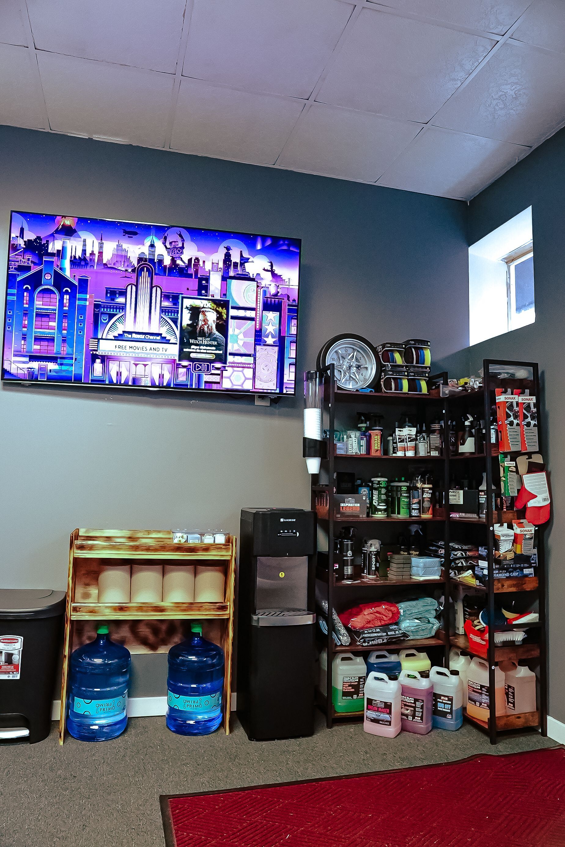 A living room with a large flat screen tv on the wall