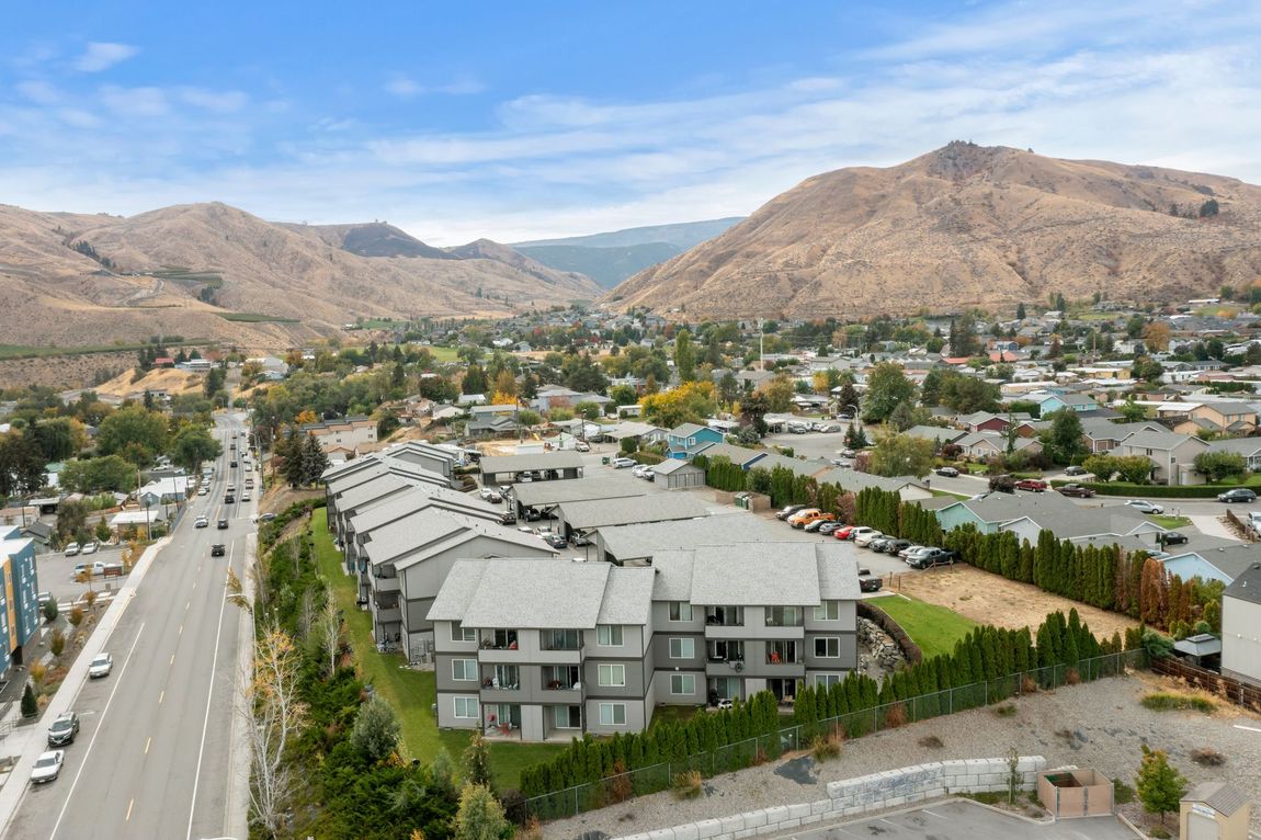 An aerial view of a city with mountains in the background.