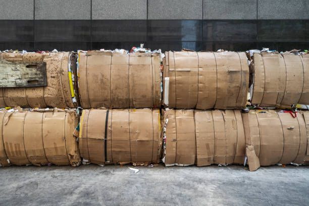 Cardboard boxes stacked against a wall, showcasing efficient storage solutions with bale wire.