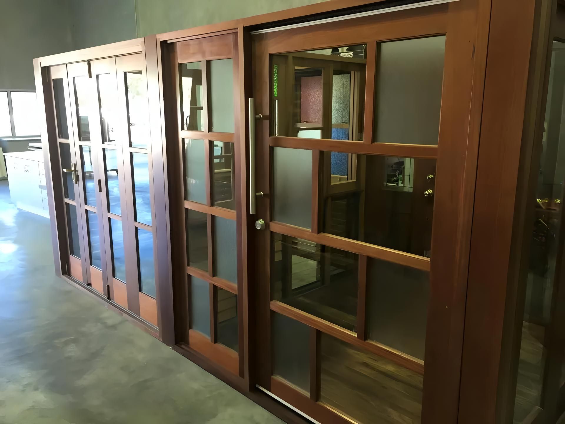 A Row of Sliding Glass Doors in a Room — Ross Joinery Kitchens In Garbutt, QLD