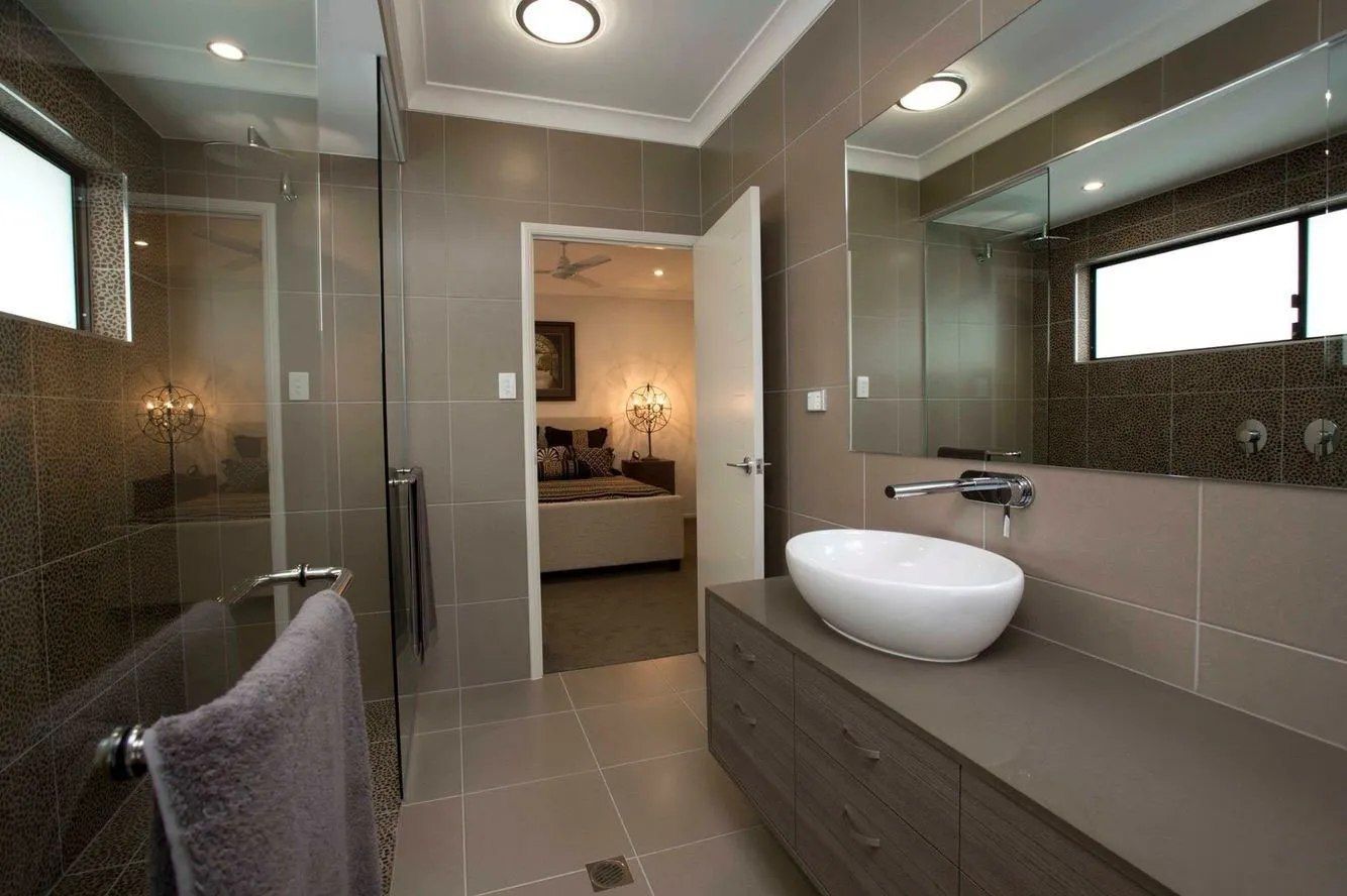 A Bathroom With a Sink, Mirror and Walk in Shower — Ross Joinery Kitchens In Garbutt, QLD