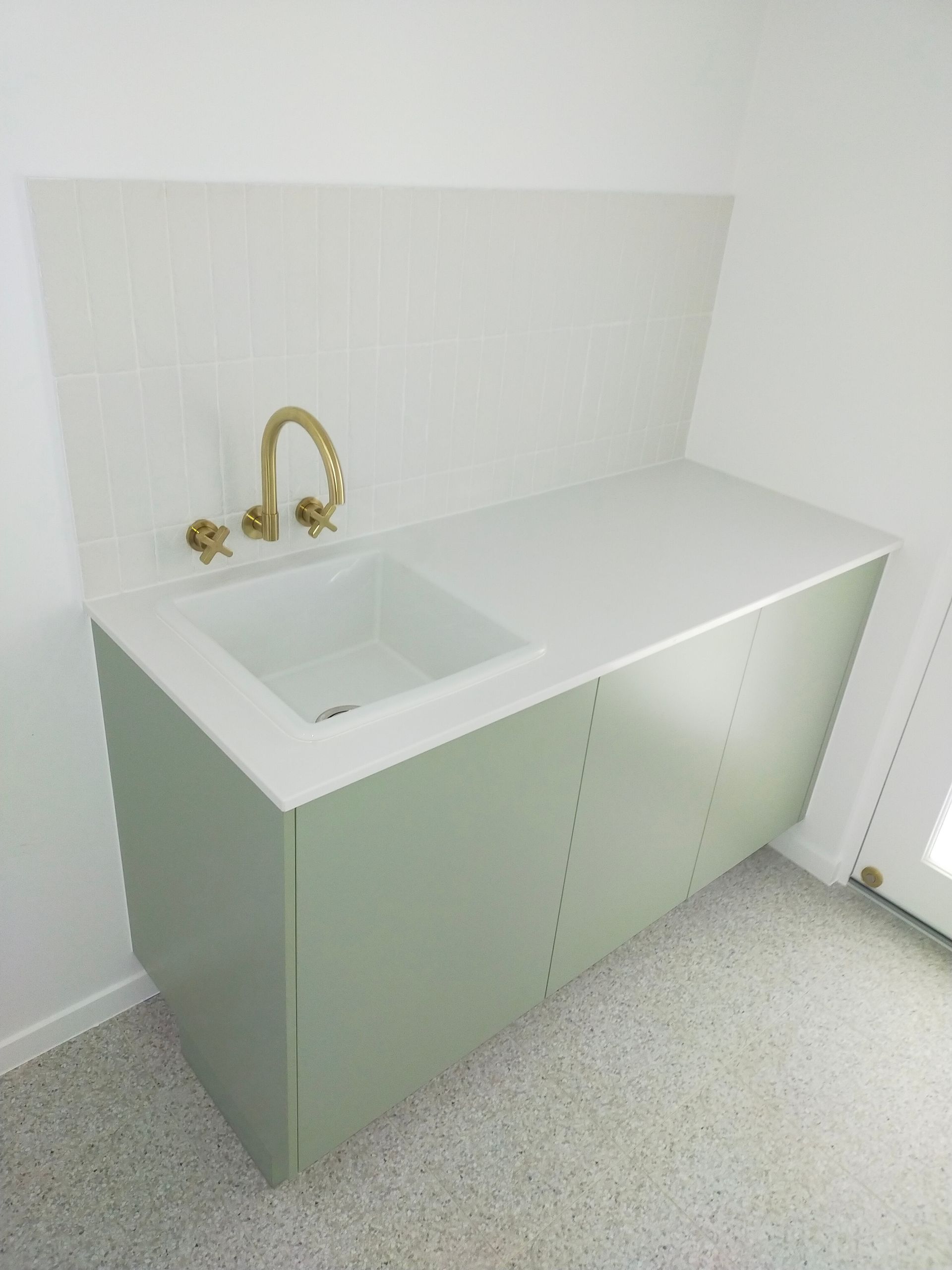 A Laundry Room With a Sink, Washer and Dryer — Ross Joinery Kitchens In Garbutt, QLD
