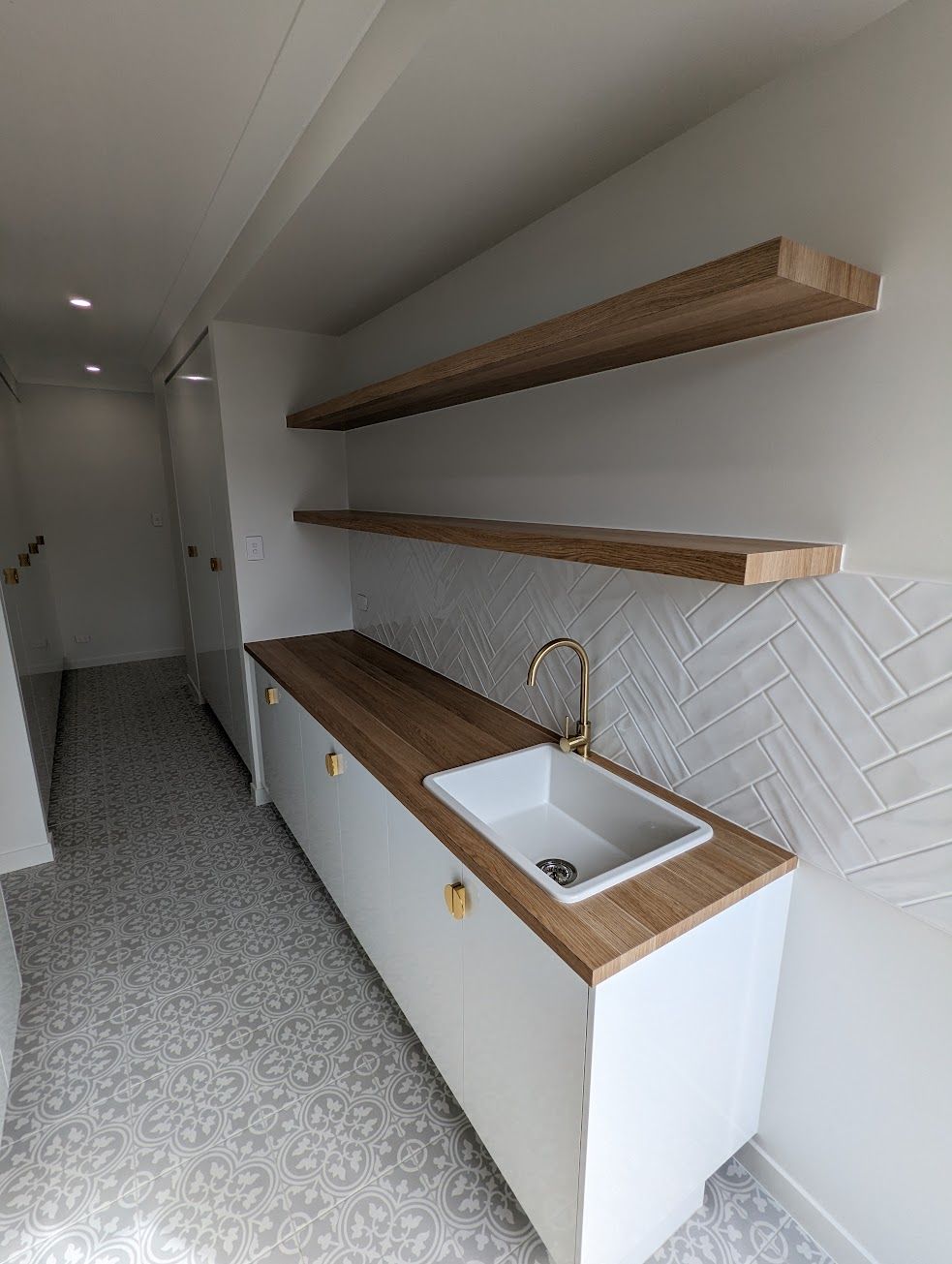 A Kitchen With a Sink and a Washer and Dryer — Ross Joinery Kitchens In Garbutt, QLD