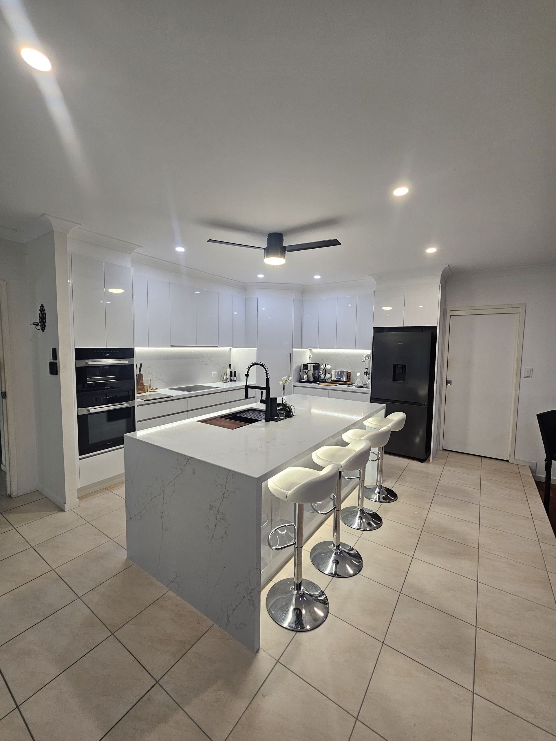 A Kitchen With a Sink and a Faucet on the Counter — Ross Joinery Kitchens In Garbutt, QLD