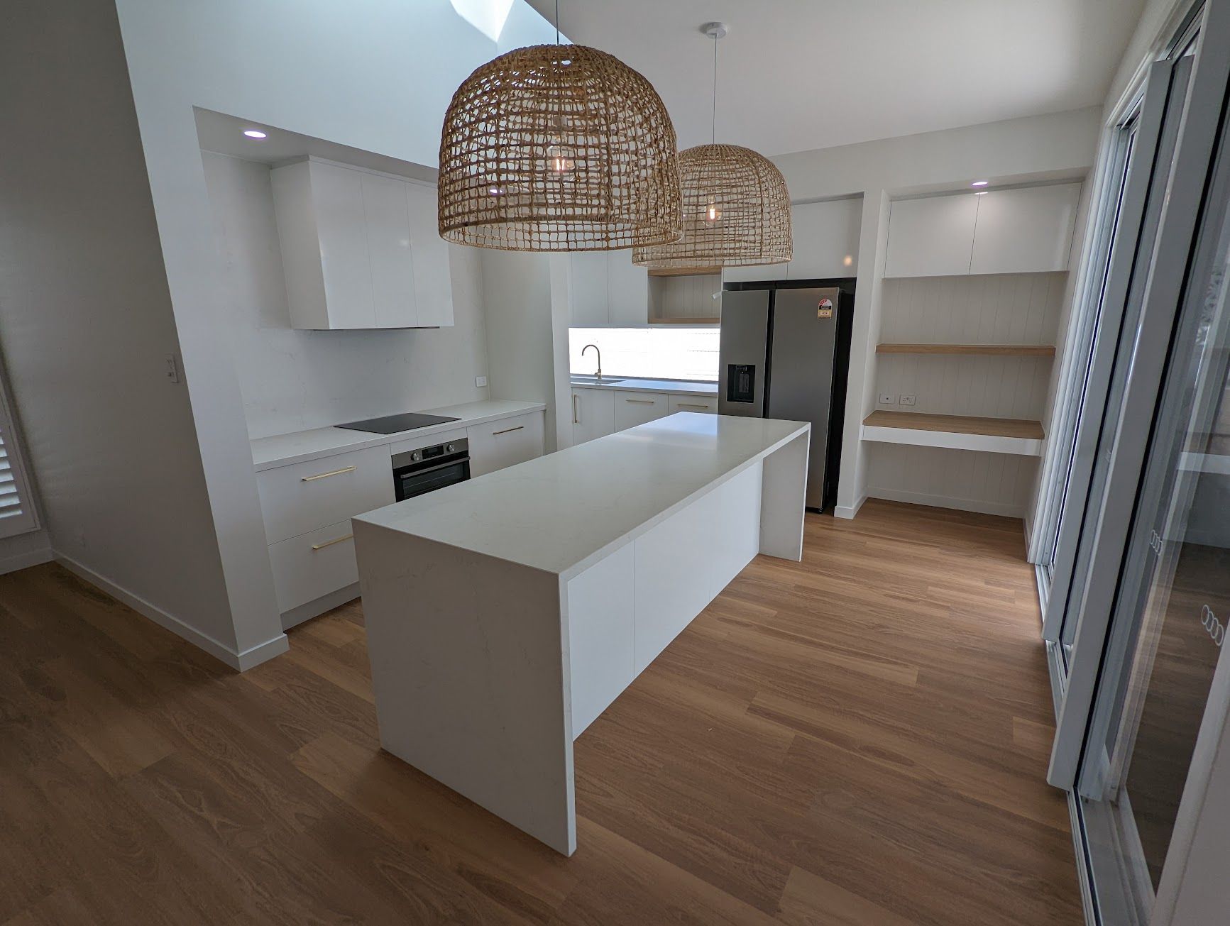A Kitchen With a Black Sink and a White Counter Top — Ross Joinery Kitchens In Garbutt, QLD