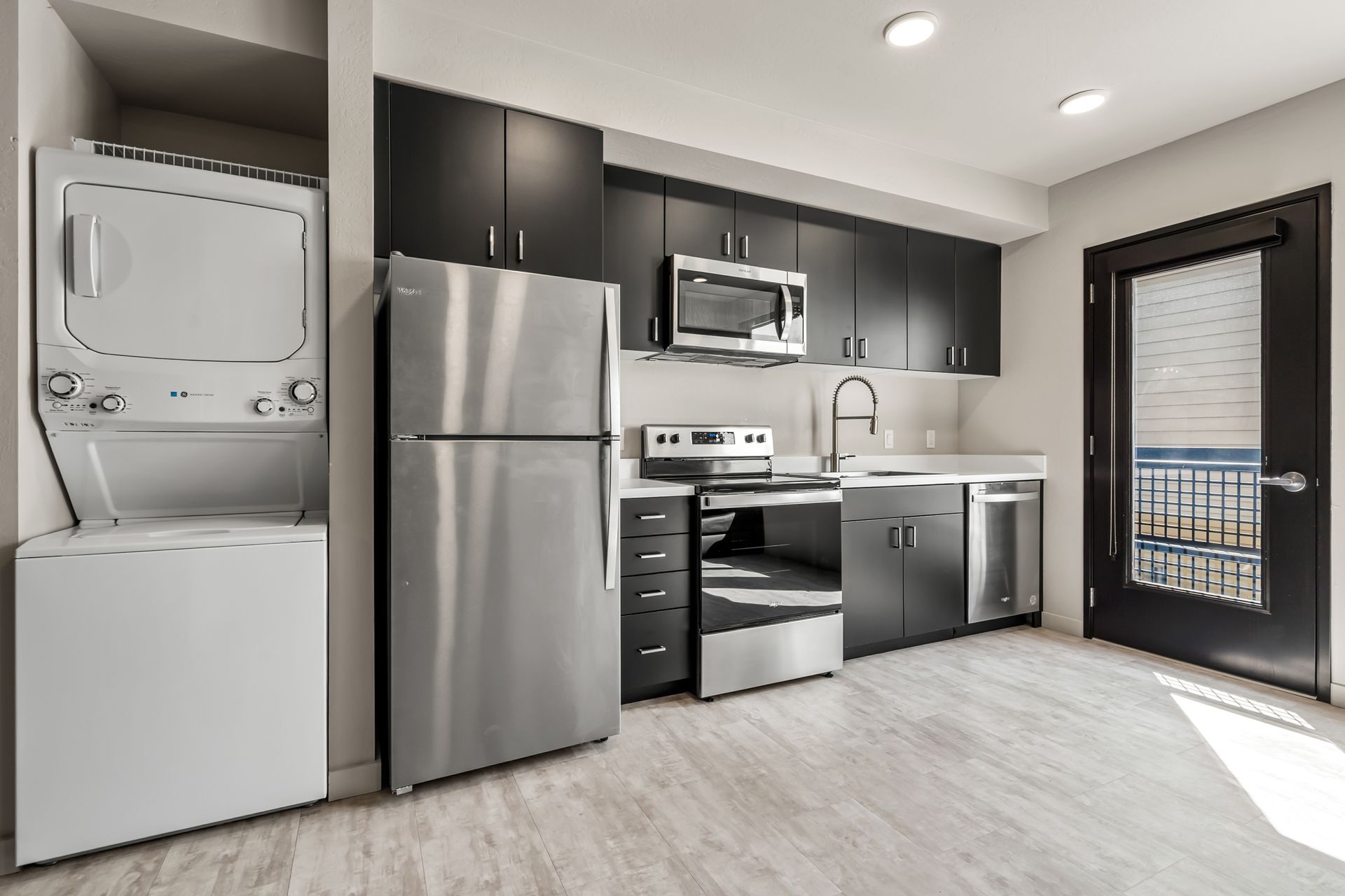 Photo of a studio apartment with a laundry area next to the kitchen