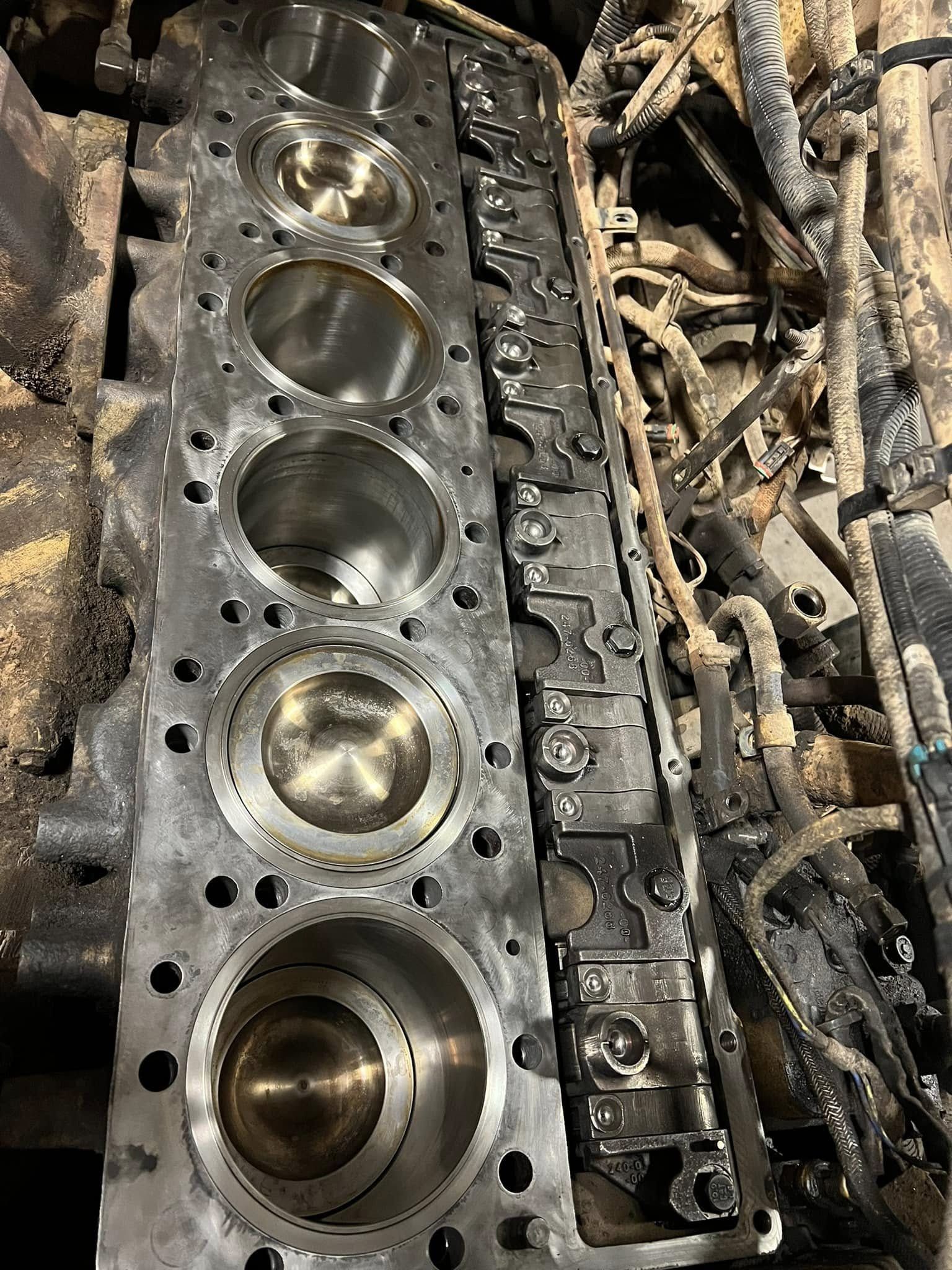Engine block with cylinder bores and valve train components, showing internal engine structure.