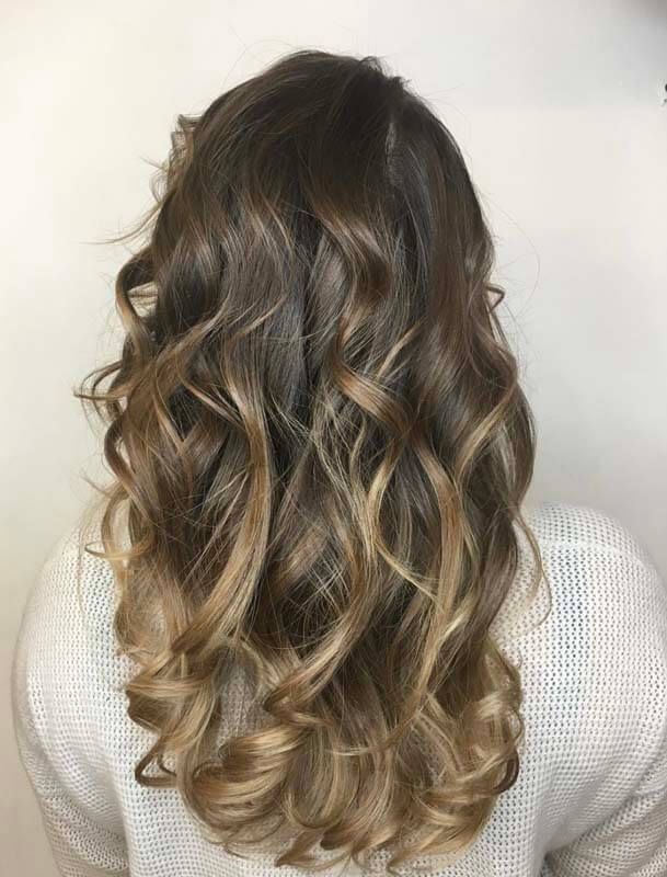 Long wavy brunette hair with blonde highlights