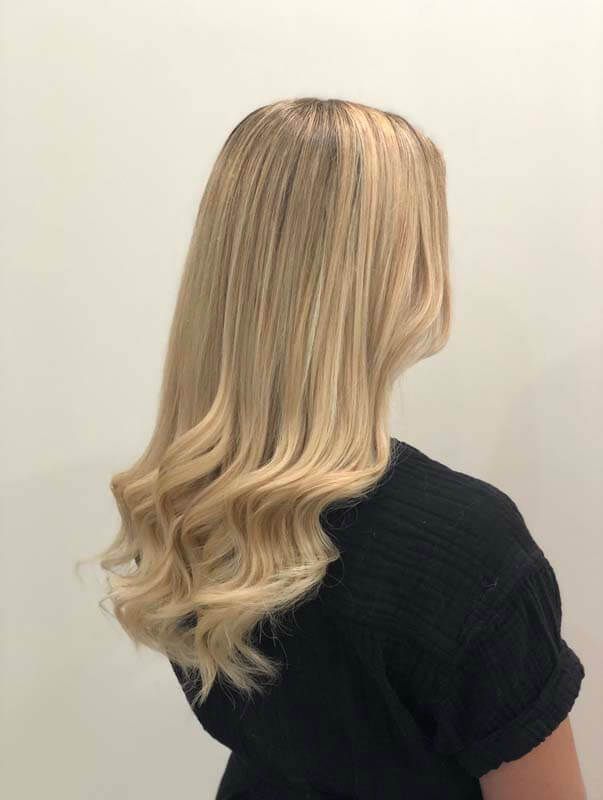 Long blonde wavy hair with subtle highlights