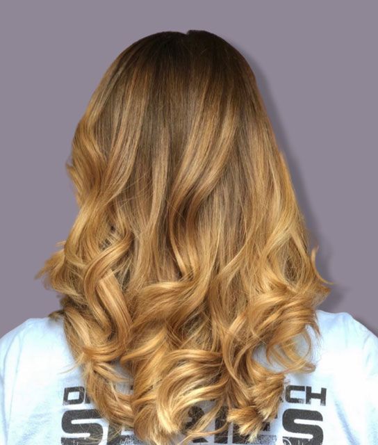 Back view of shoulder-length wavy blonde hair
